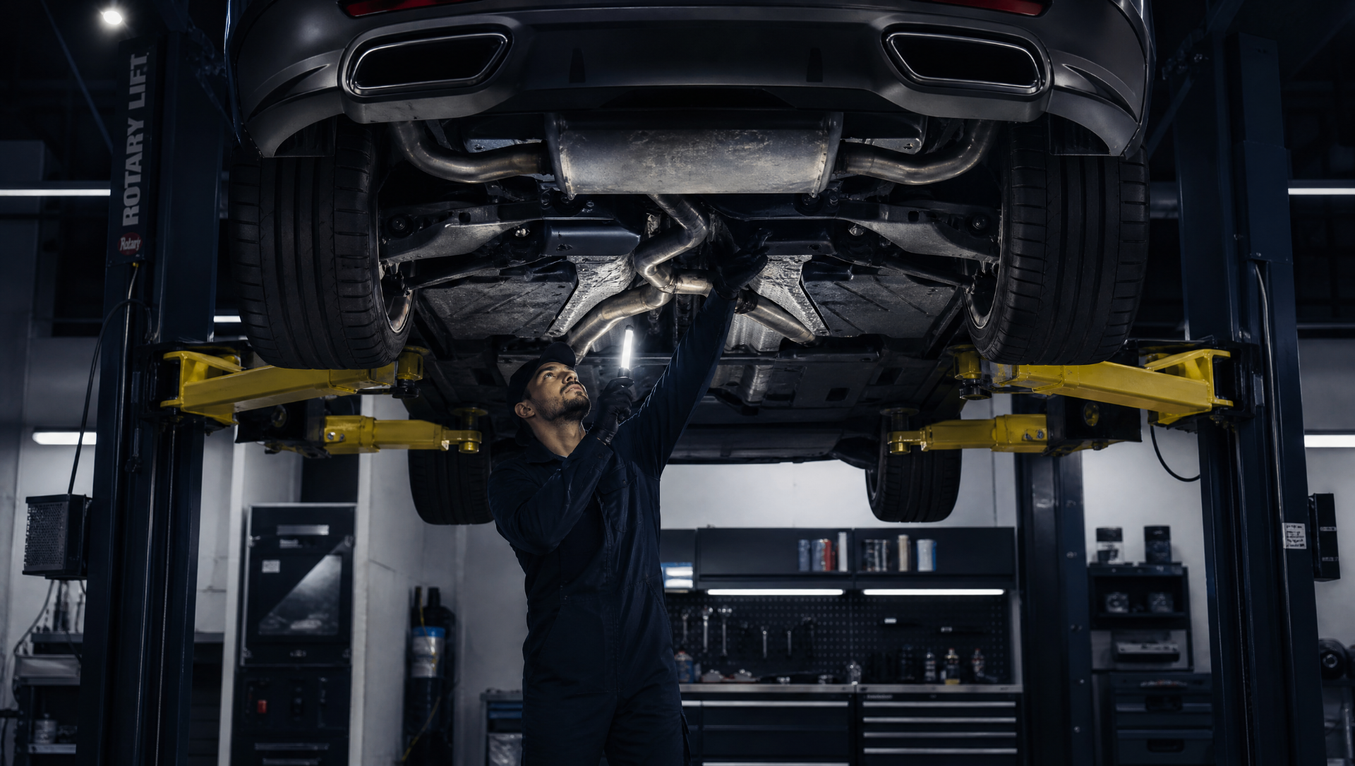 Mechaniker arbeitet unter angehobenem Fahrzeug